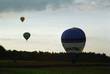 Heißluftballon hebt gerade ab, im Hintergrund 2 Ballons in der Luft